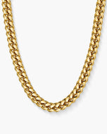 Gold Cuban chain necklace on a white background